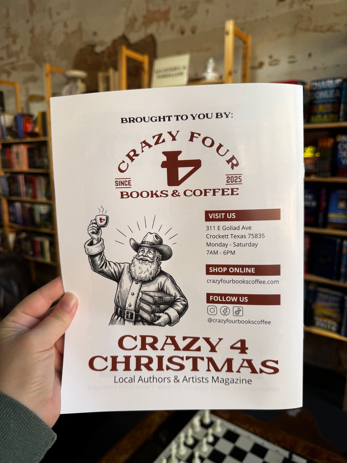Hand holding a magazine titled 'Crazy 4 Christmas' with a store interior in the background.
